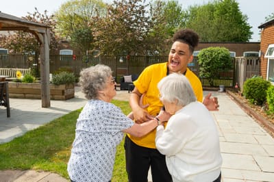 Residents and staff enjoying outdoor activities together.