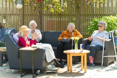 Residents enjoying time outdoors in a common area.