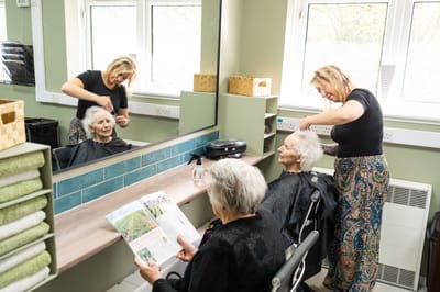 Residents getting hair services in a salon area