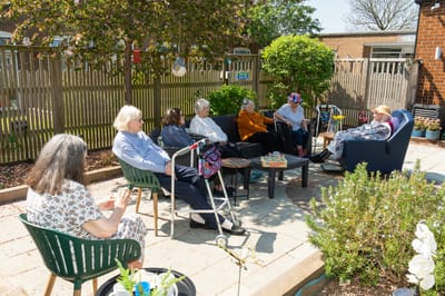 Residents socializing in an outdoor courtyard