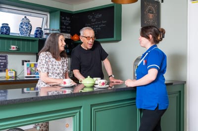 Residents interacting with staff in a common area