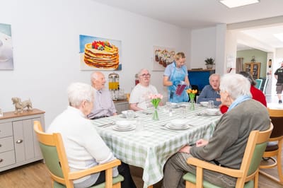 Residents enjoying a meal together in a dining room