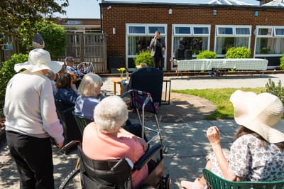 Residents enjoying an outdoor performance