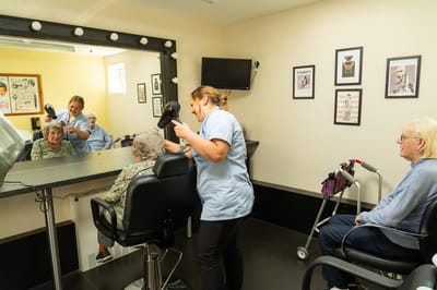 Residents enjoying hair salon services.