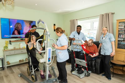 Staff assisting residents with mobility equipment