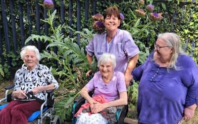 Residents and staff enjoying time outdoors together.