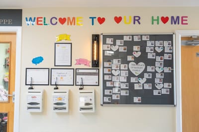 Colorful welcome sign and community bulletin board.