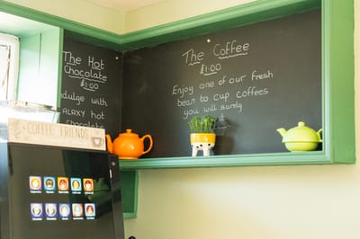 Coffee menu and equipment in a cozy café setting