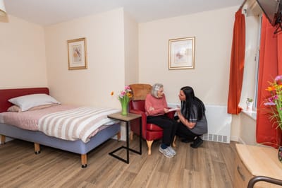 Resident and staff member engaged in conversation