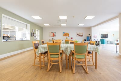 Dining area with tables and chairs.