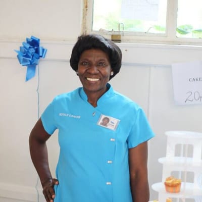 Staff member smiling at celebration event.