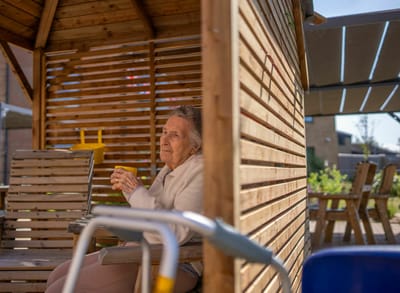 Senior sitting outside in a gazebo