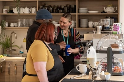 Staff engaging with residents in a communal kitchen