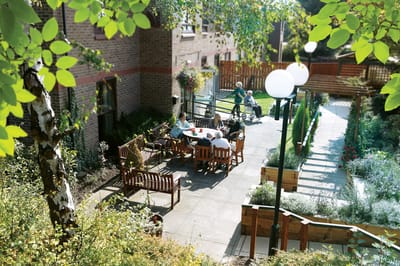 Residents enjoying time in an outdoor space with seating.