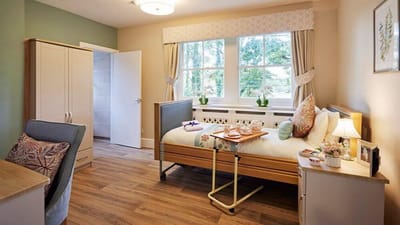 Well-furnished resident room with natural light.
