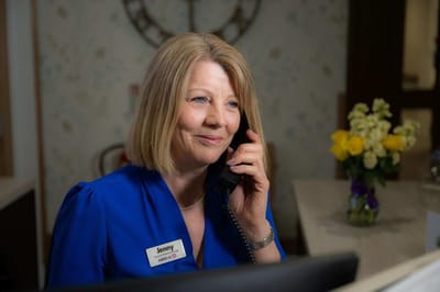 Receptionist talking on the phone at the facility