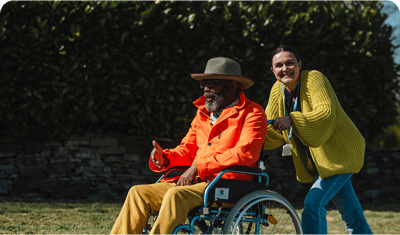 Resident and staff member enjoying outdoor time.
