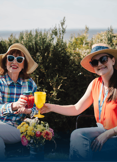 Residents enjoying drinks outdoors with staff