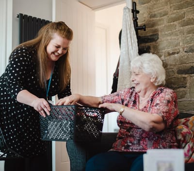 Staff member assisting a resident with a basket
