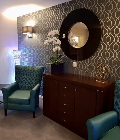 Comfortable seating area with decorative wall