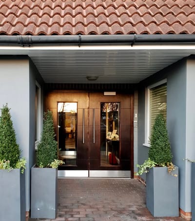 Entrance of Sycamore Care Center with planters