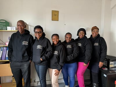 A group of staff members in hoodies.