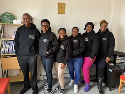 Staff members wearing branded hoodies together.