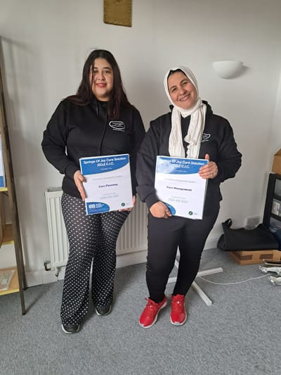 Staff members holding care service certificates