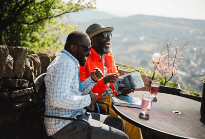 Two men enjoying a sunny outdoor moment together.
