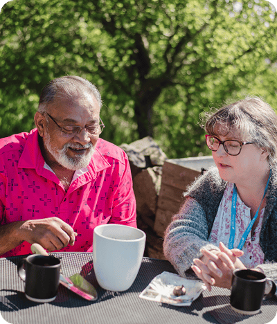 Two residents enjoying conversation outdoors