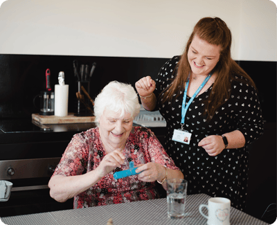 Resident and staff engaged in an activity.