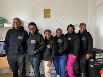 Staff members in matching hoodies, smiling together