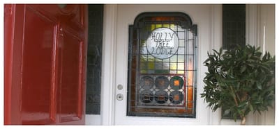 Entrance door with stained glass panel of Holly Tree Lodge