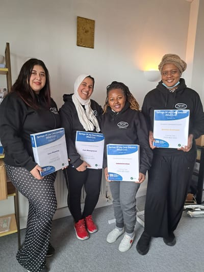 Staff members holding certification awards