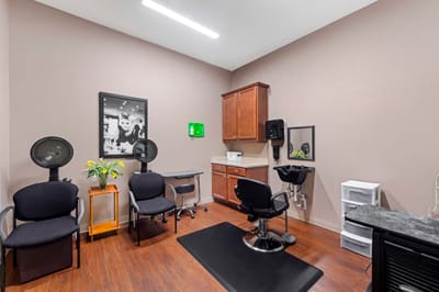 Hair salon area with styling chairs and equipment.