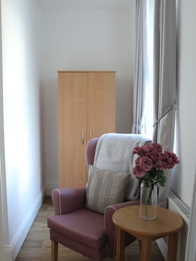 Cozy corner of a resident room with flowers.