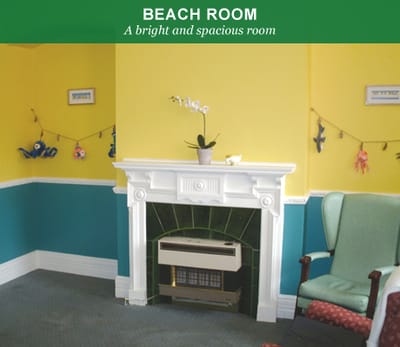Beach room with a fireplace and colorful walls
