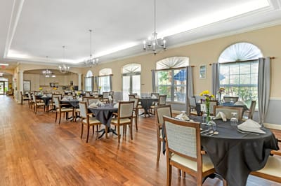 Dining room setup with tables and chairs.