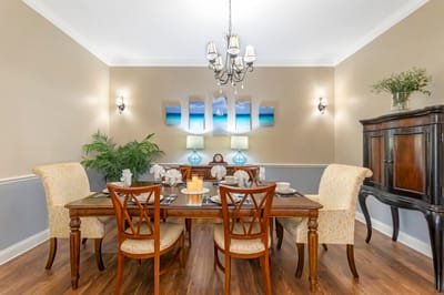 Elegant dining room setup with table and chairs.