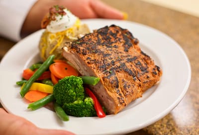 Plated meal with grilled meat and vegetables