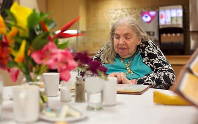 Senior resident engaged in a dining area