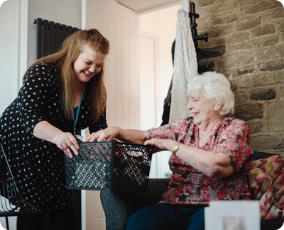 Staff member assisting a resident with a basket