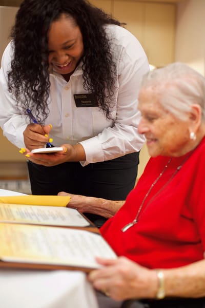 Staff assisting a resident with menu choices