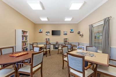 Common area with tables and bookshelves.