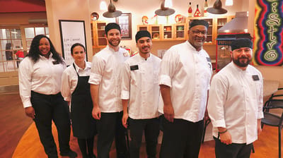 Staff members posing in dining area