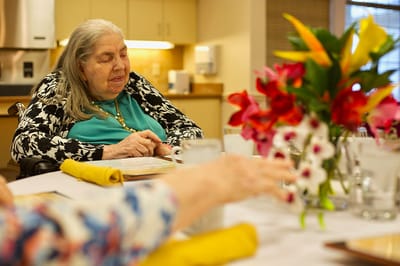 Resident enjoying a meal in the dining area.