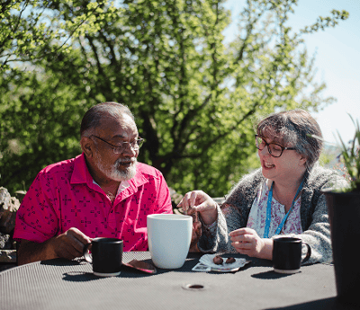 Two residents enjoying a conversation outdoors.