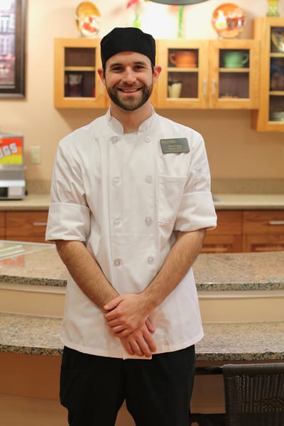 Smiling chef in a kitchen setting