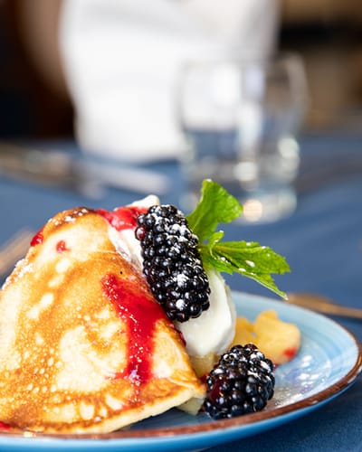 Delicious dessert with fresh blackberries and cream.