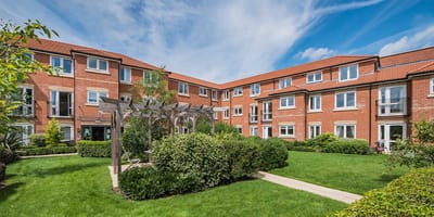 Well-maintained courtyard with greenery and residential buildings.